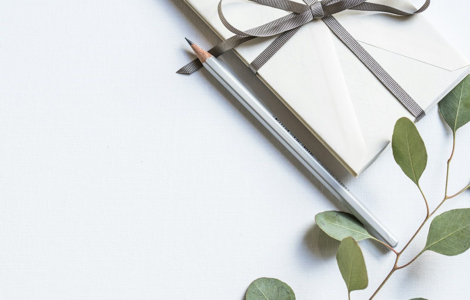 flat lay photo of book and pencil