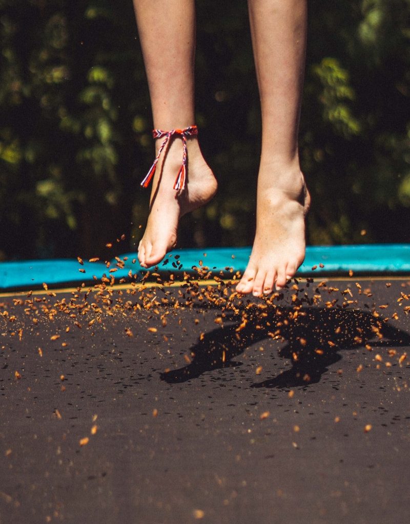 person wearing red and black flip flops