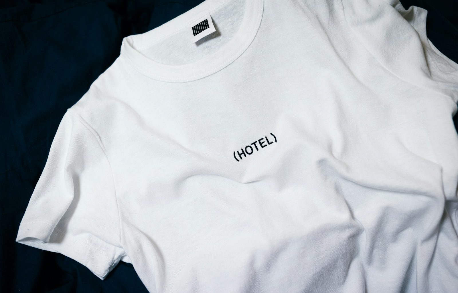 white hotel-printed crew-neck shirt on black surface