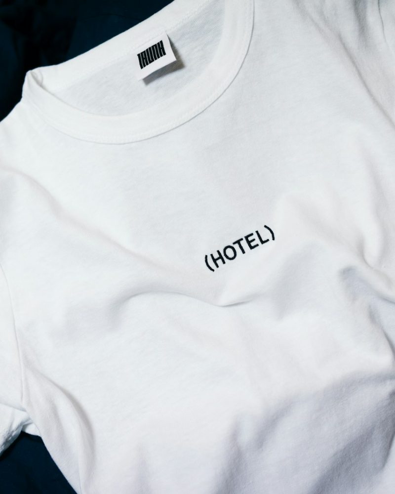 white hotel-printed crew-neck shirt on black surface