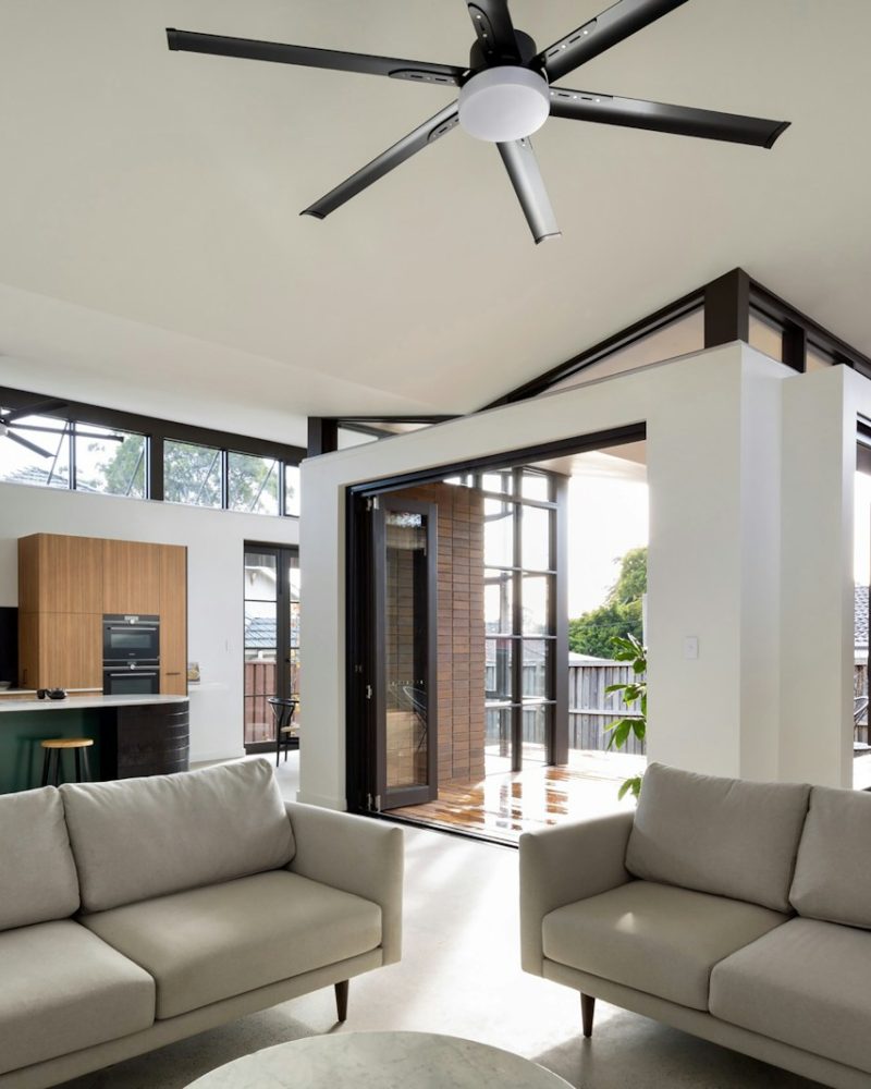 a living room with a large ceiling fan