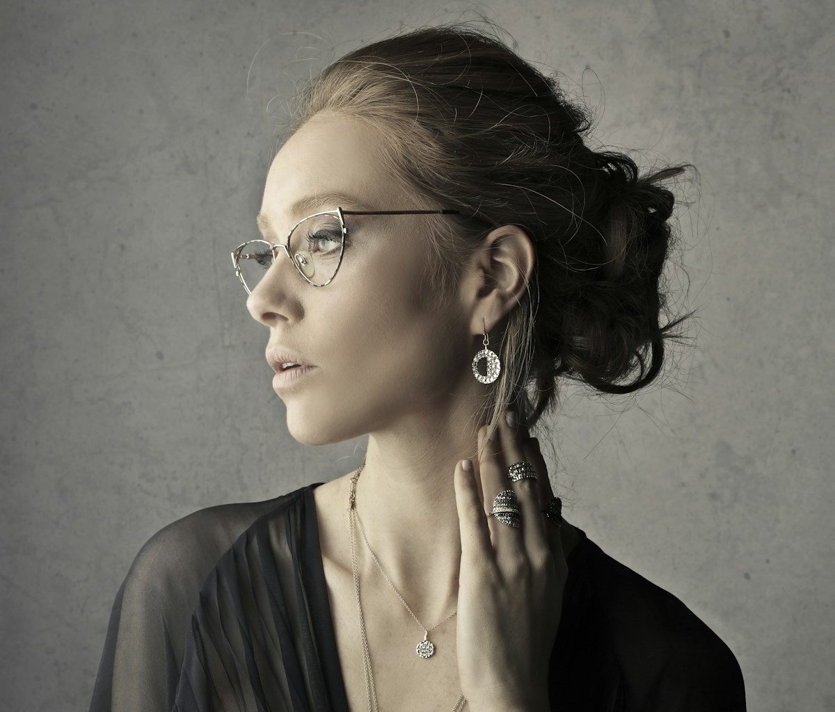 woman holding her neck while facing left