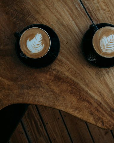 two coffee arts on brown wooden table