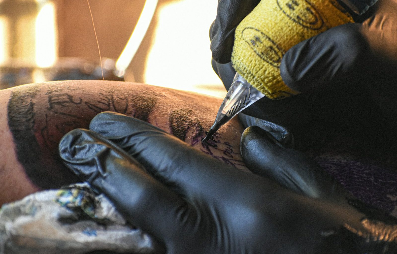 A man getting a tattoo on his leg