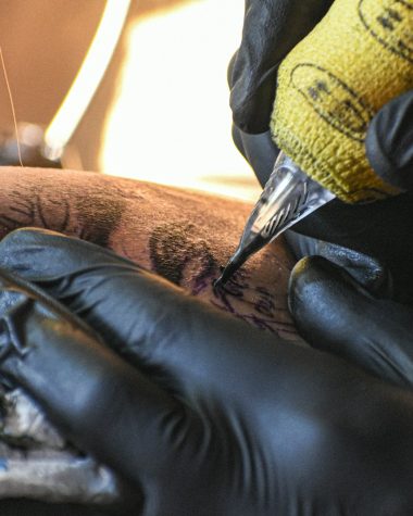A man getting a tattoo on his leg